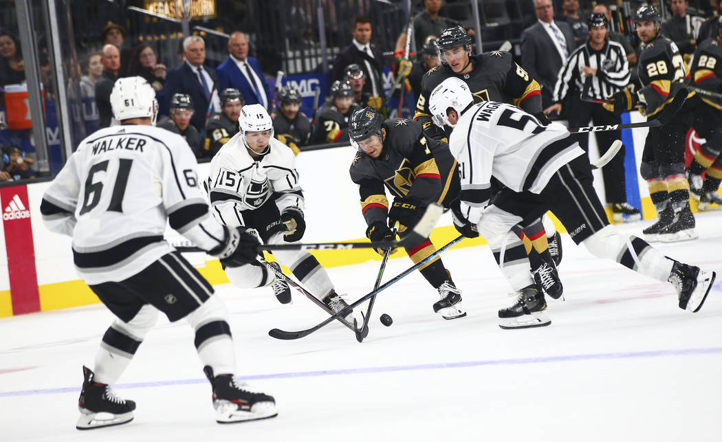 Golden Knights' Valentin Zykov (7) battles for the puck between Los Angeles Kings' Ben Hutton ( ...