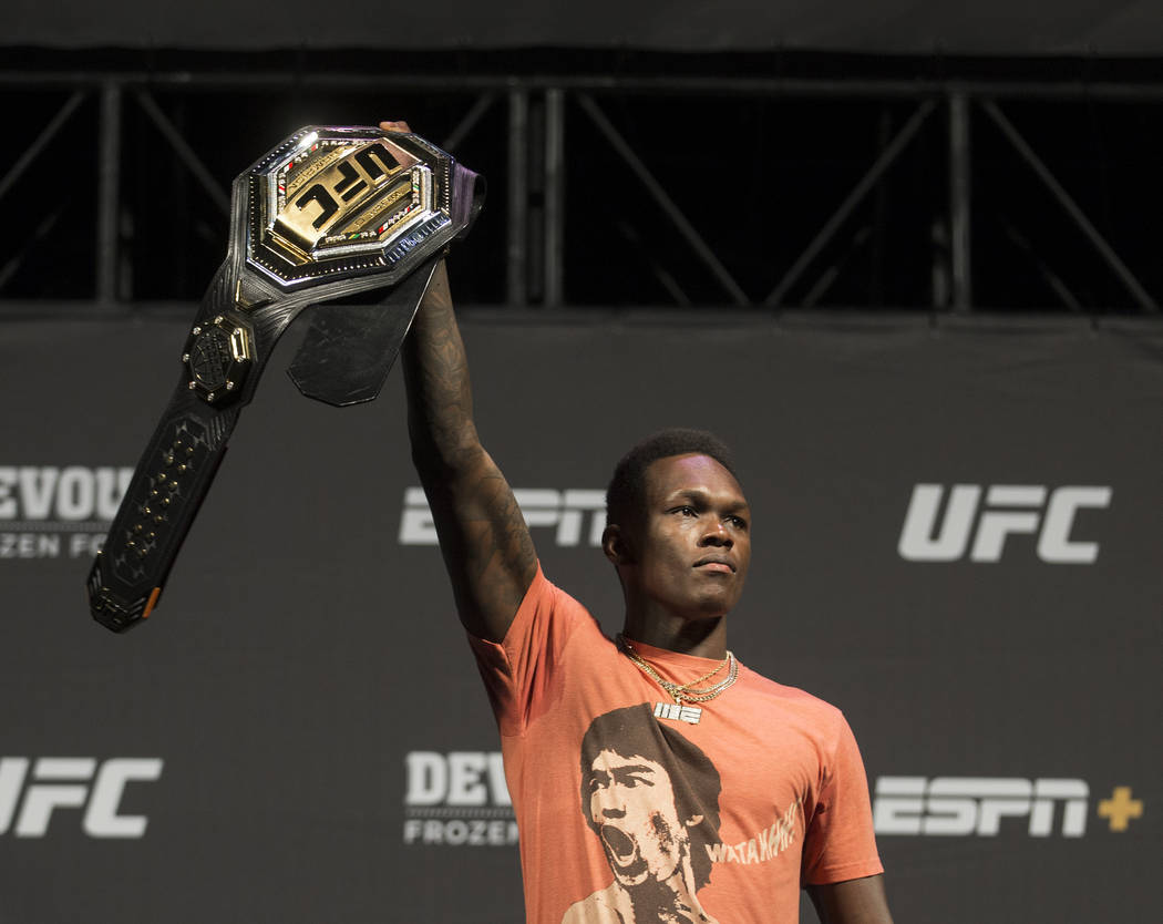 UFC interim middleweight champion Israel Adesanya holds up his belt during a press conference o ...