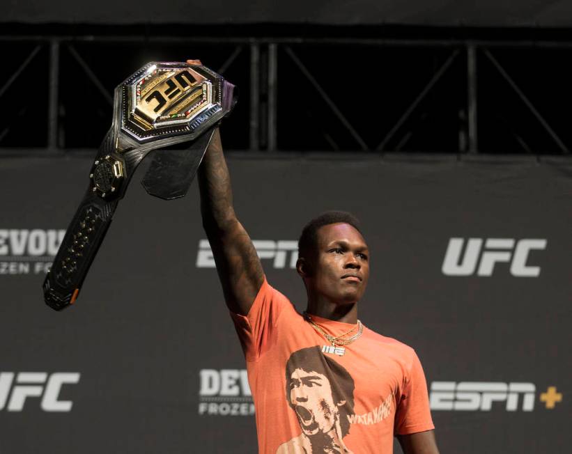 UFC interim middleweight champion Israel Adesanya holds up his belt during a press conference o ...