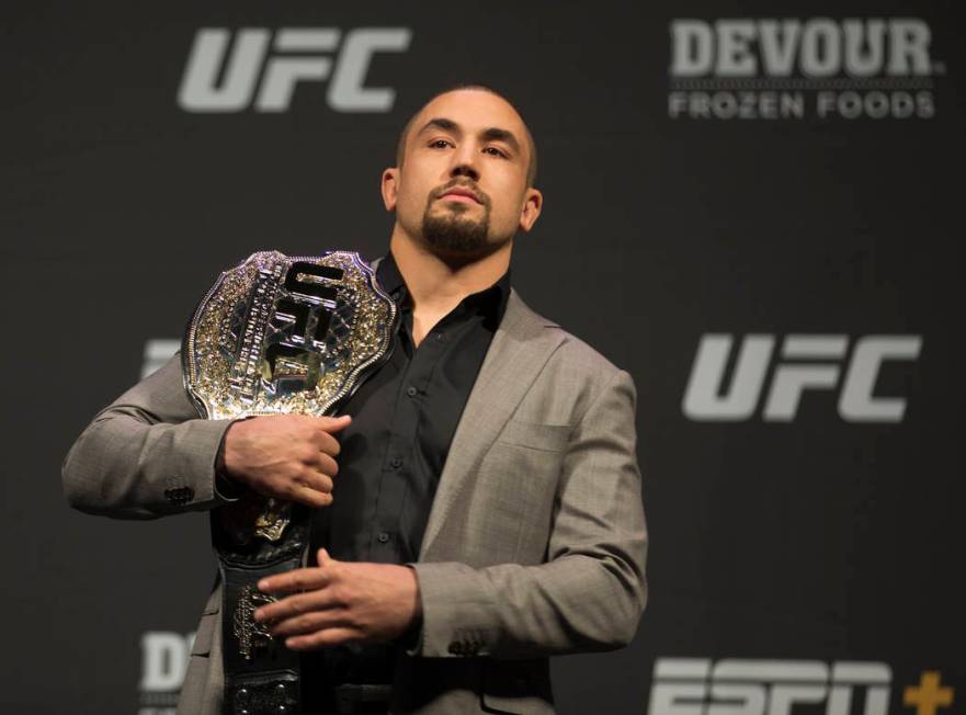 UFC middleweight champion Robert Whittaker holds his belt during a press conference on Friday, ...