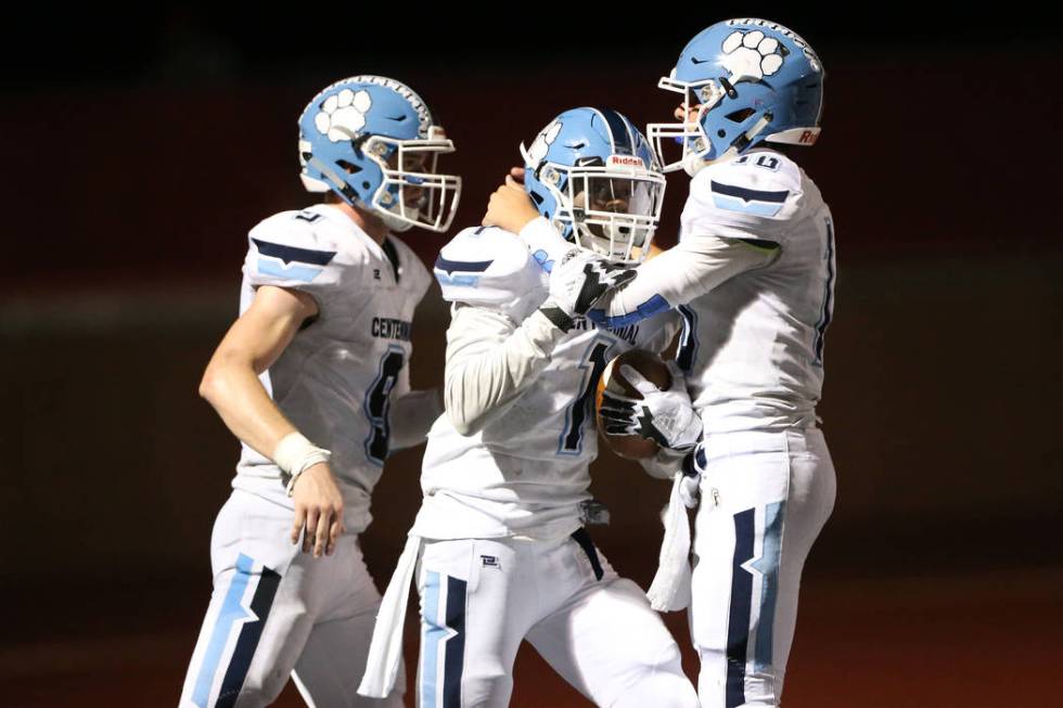 Centennial's Jordan Smith (1) celebrates his touchdown run with Nate Conger (9) and Colton Tenn ...