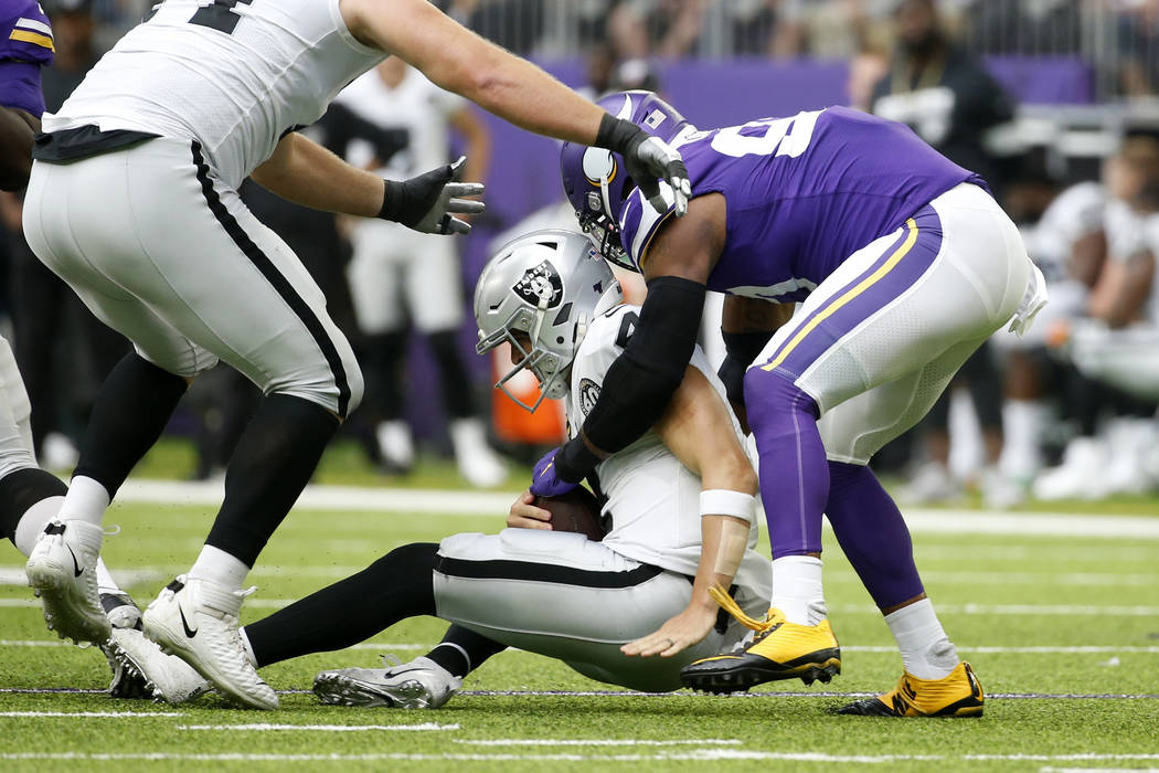 Minnesota Vikings defensive end Everson Griffen, right, sacks Oakland Raiders quarterback Derek ...