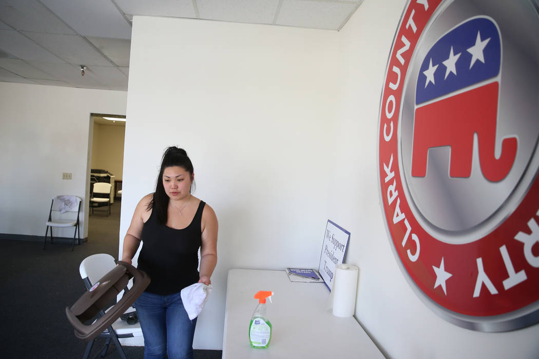 Tiffany Fung, political director of the Clark County Republican Party, cleans up after a break- ...