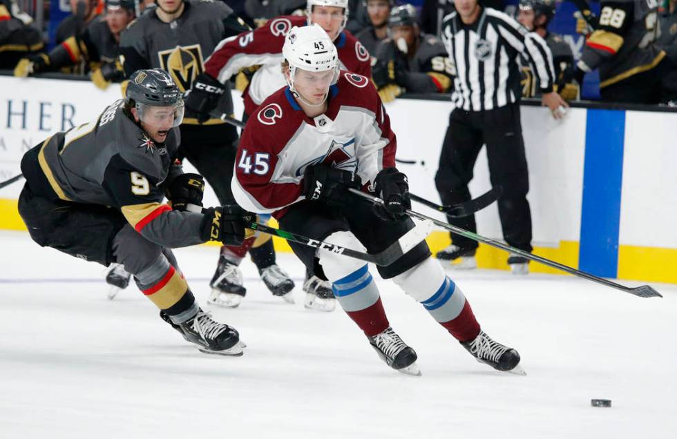 Vegas Golden Knights center Cody Glass (9) vies for the puck with Colorado Avalanche defenseman ...