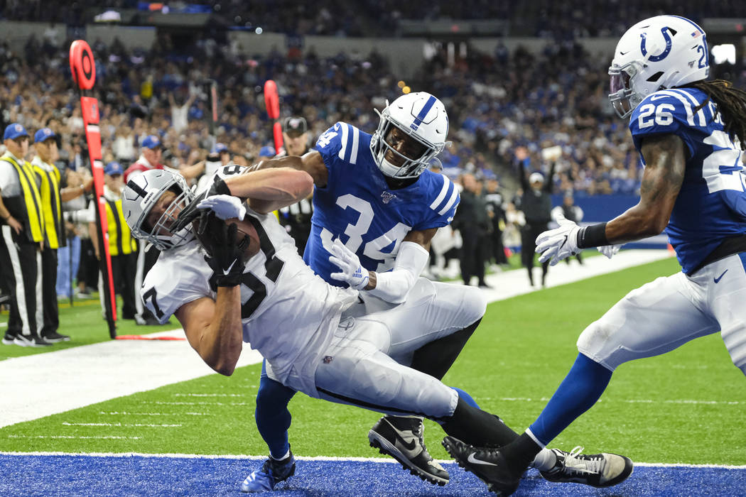 Oakland Raiders tight end Foster Moreau (87) makes a catch for a touchdown in front of Indianap ...