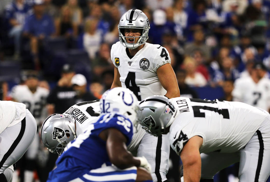 Oakland Raiders quarterback Derek Carr (4) calls an audible at the line of scrimmage during the ...