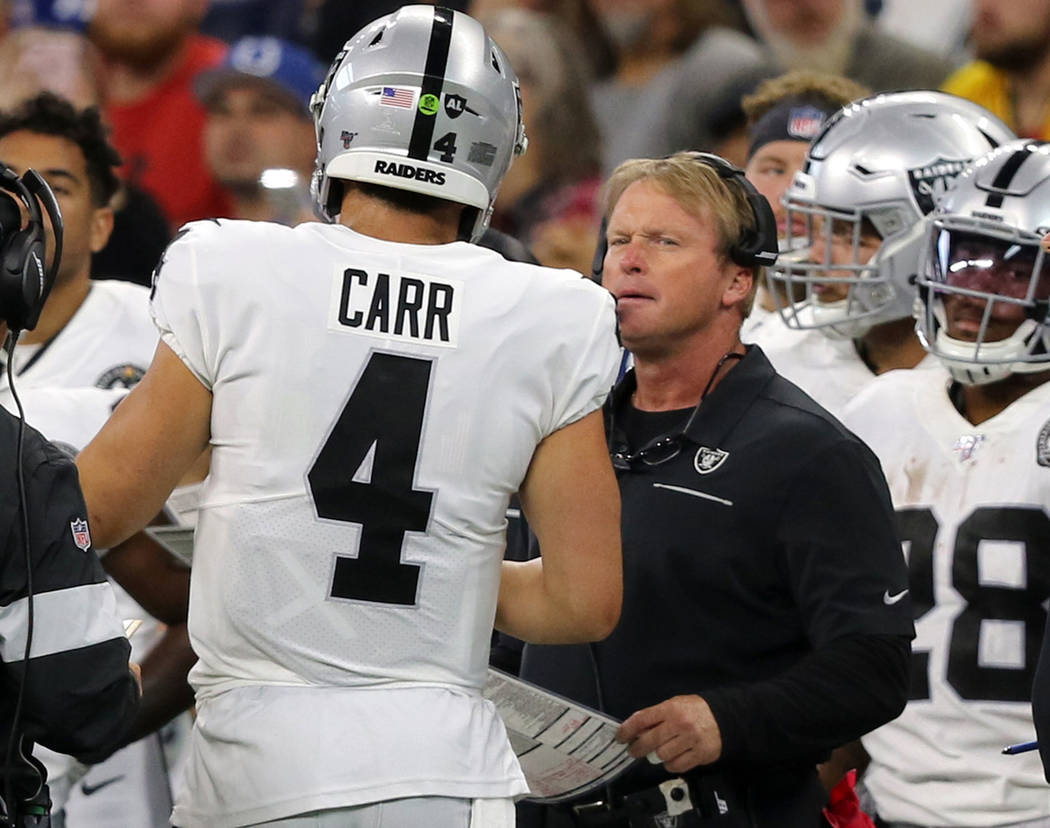 Oakland Raiders quarterback Derek Carr (4) speaks to head coach Jon Gruden on the sideline duri ...