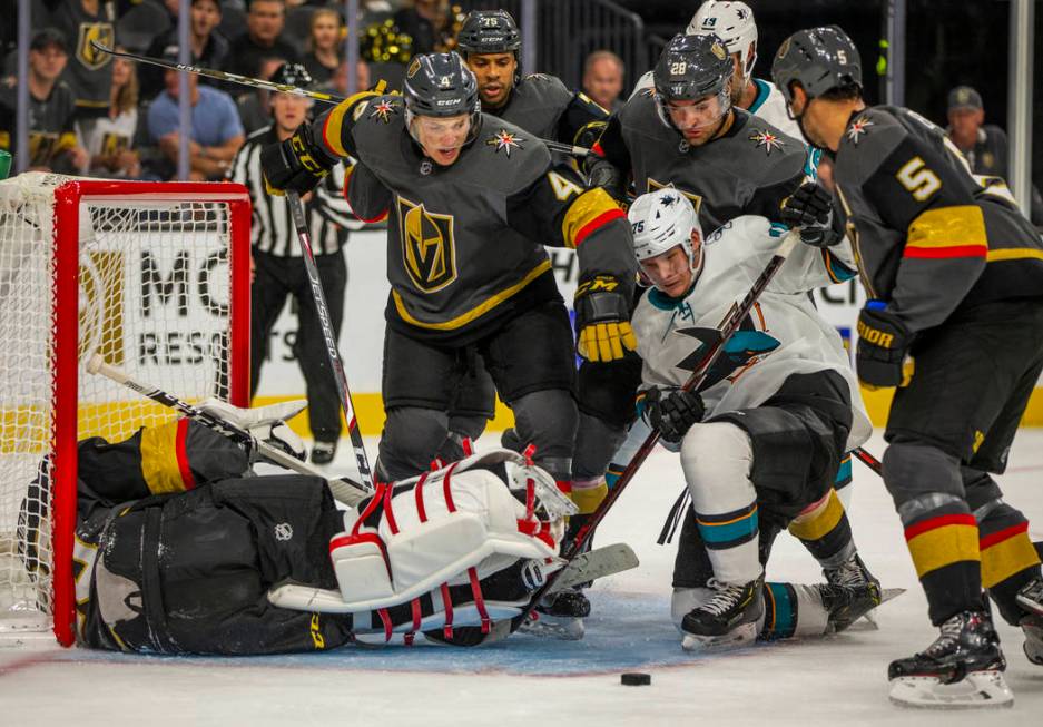 Vegas Golden Knights goaltender Marc-Andre Fleury (29) is down as his teammates help defend the ...