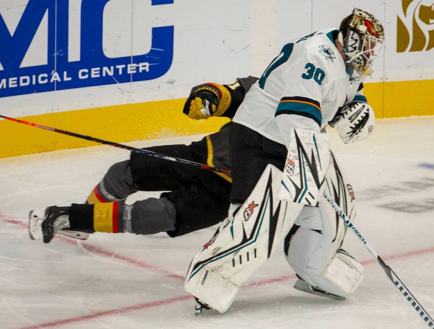 San Jose Sharks goaltender Aaron Dell (30) trips up Vegas Golden Knights right wing Mark Stone ...