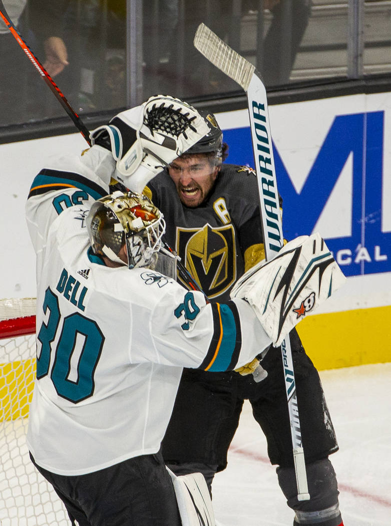 San Jose Sharks goaltender Aaron Dell (30) is struck by Vegas Golden Knights right wing Mark St ...