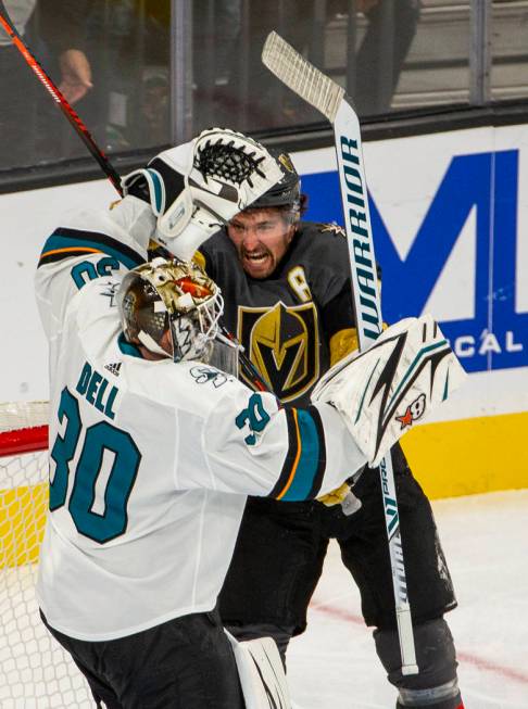 San Jose Sharks goaltender Aaron Dell (30) is struck by Vegas Golden Knights right wing Mark St ...