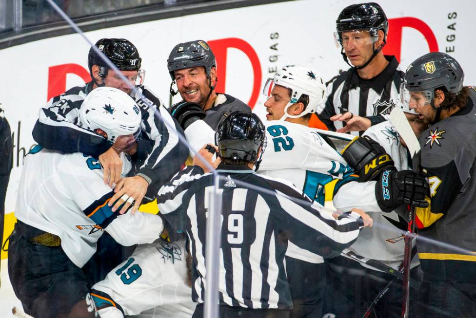 Vegas Golden Knights Deryk Engelland (5), center, fights with San Jose Sharks Timo Meier (28), ...