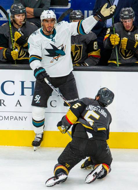 San Jose Sharks left wing Evander Kane (9, top) trips up Vegas Golden Knights defenseman Deryk ...