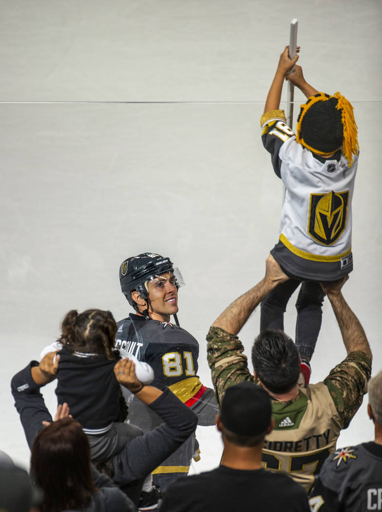 Vegas Golden Knights center Jonathan Marchessault (81) gives his stick to a lucky fan following ...