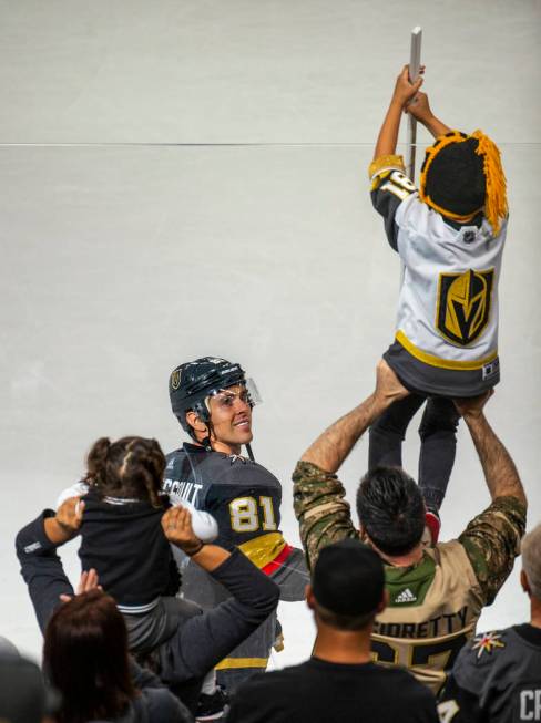 Vegas Golden Knights center Jonathan Marchessault (81) gives his stick to a lucky fan following ...