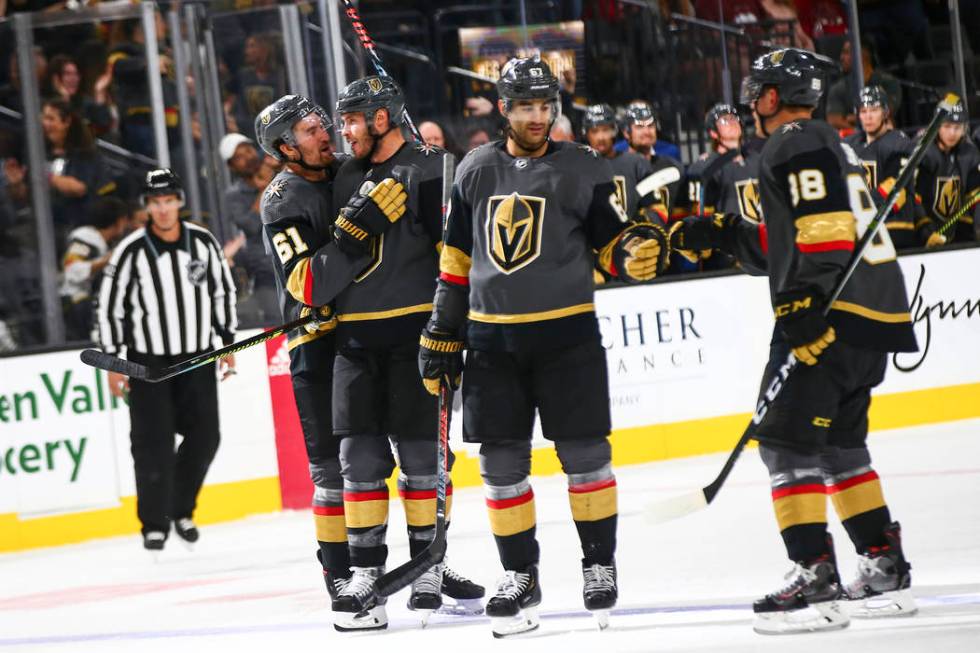 Golden Knights' Max Pacioretty, third from left, celebrates his goal with Nate Schmidt (88) alo ...