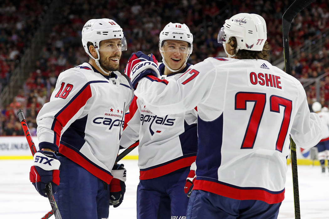 Washington Capitals' T.J. Oshie (77) celebrates his goal with teammate Chandler Stephenson (18) ...