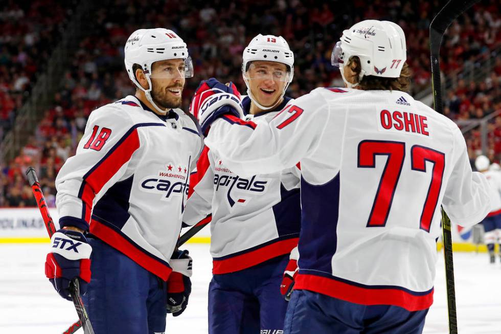 Washington Capitals' T.J. Oshie (77) celebrates his goal with teammate Chandler Stephenson (18) ...