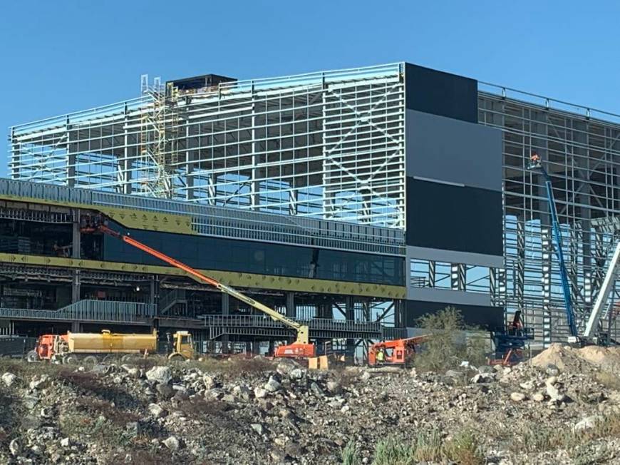 Glass installation and side panel installation progresses on the Raiders Henderson headquarters ...