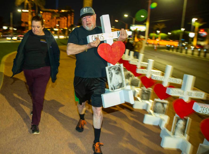 Michael and Leah Tuckman carry away a cross for Chris Roybal which they will present to his mot ...