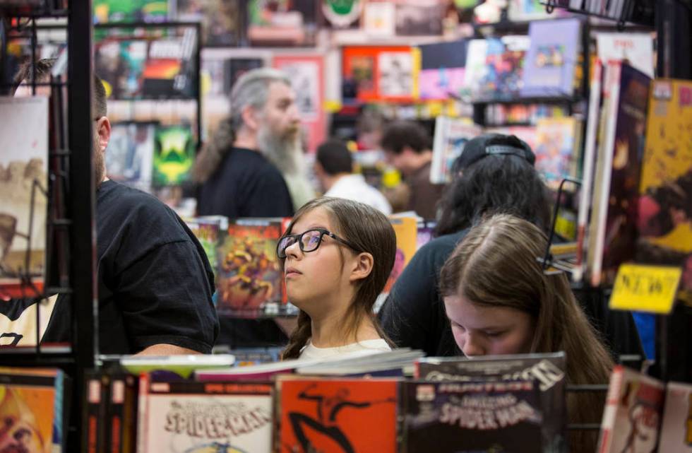 Shoppers peruse the aisles at Alternate Reality Comics during free comic book day at on Saturda ...
