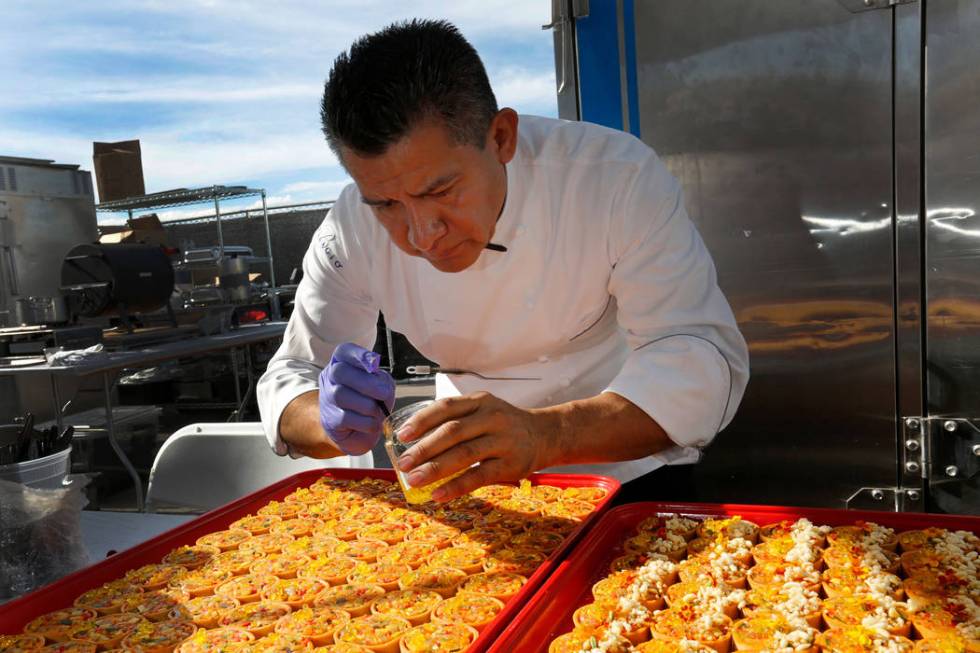 Le Cirque Chef Noe Loyola prepares samples during a food event, Martha Stewart Wine & Food ...