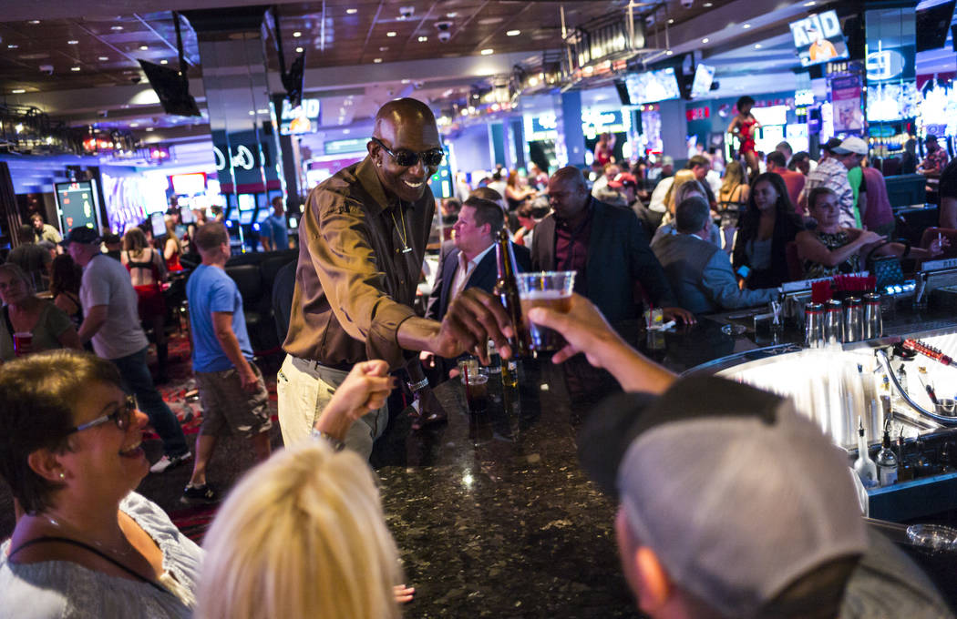 George Bell, who stands 7 feet 8 inches tall, mingles with people while hanging out at the Long ...