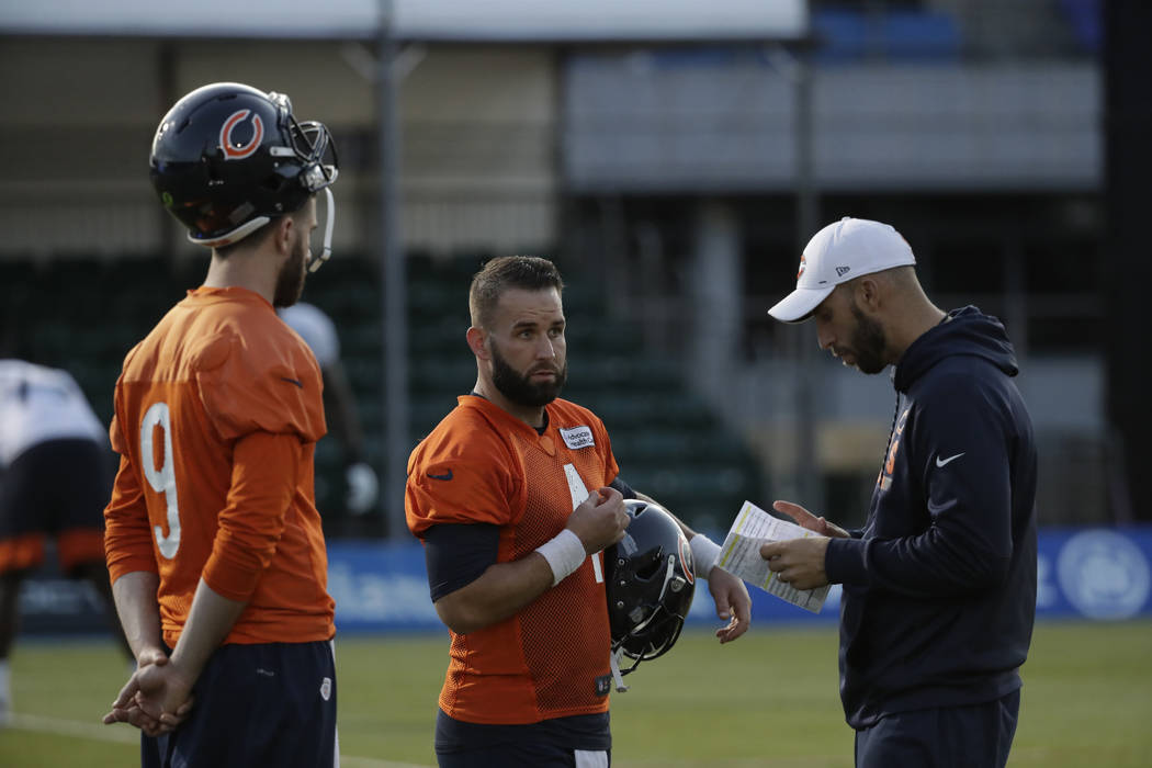 Chicago Bears' quarterback Chase Daniel, center, speaks to quarterback coach Dave Ragone, right ...