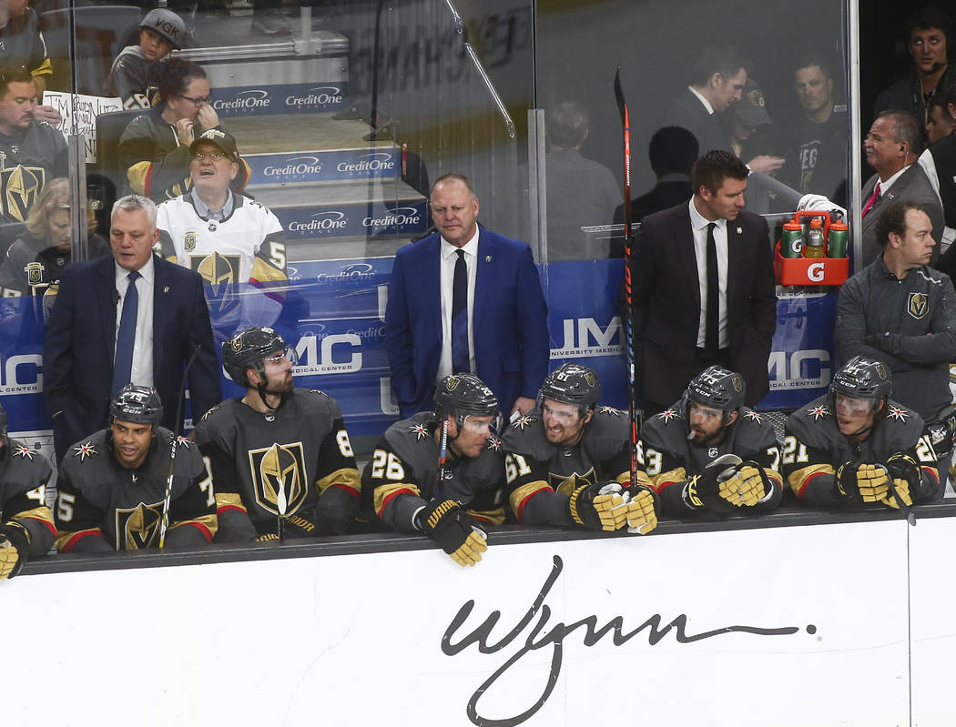 Golden Knights head coach Gerard Gallant, in blue, looks on during the third period of an NHL h ...