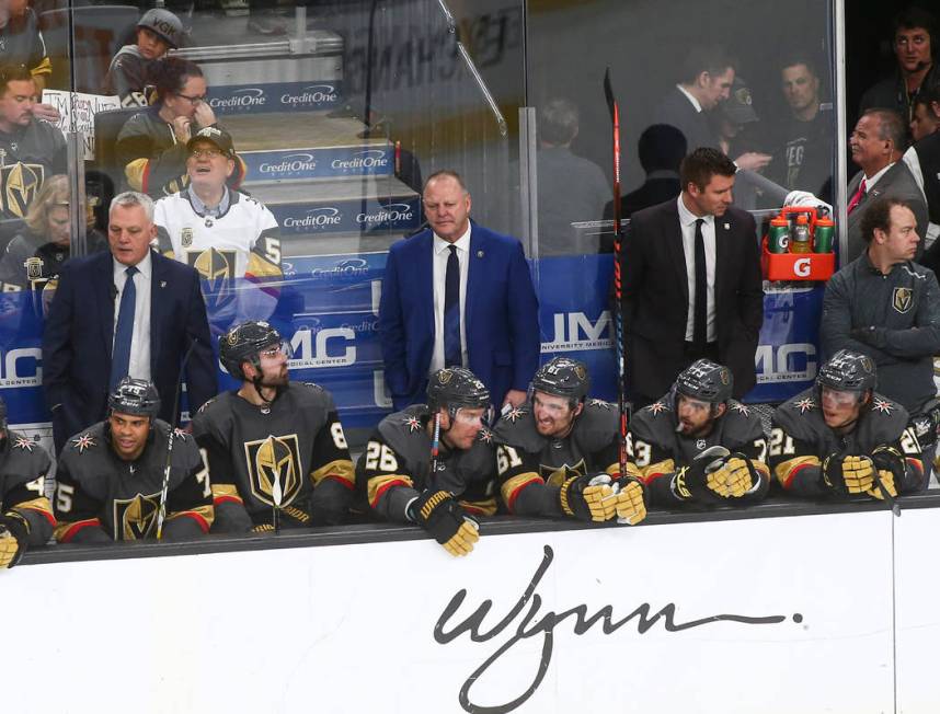 Golden Knights head coach Gerard Gallant, in blue, looks on during the third period of an NHL h ...