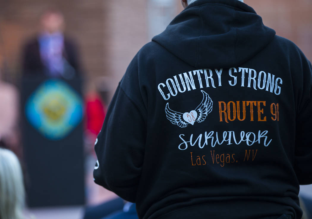 A Route 91 Harvest festival survivor listens during a sunrise ceremony at the Clark County Gove ...