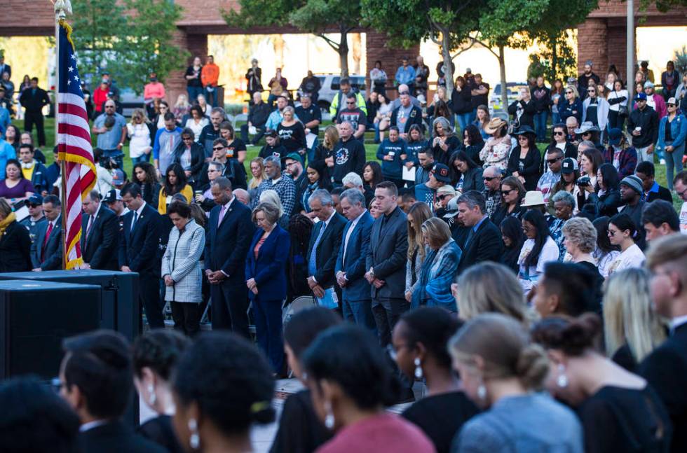 Attendees observe a moment of silence during a sunrise ceremony at the Clark County Government ...