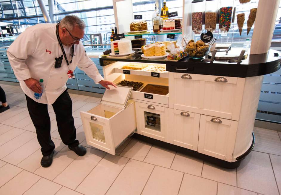 Rick Giffen, executive chef with Levy, shows off the milk bottles available for cookies and oth ...