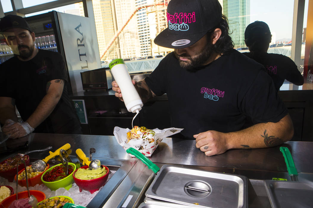 Graffiti Bao and Pina Nachos owner and chef Marc Marrone prepares nachos before the start of a ...