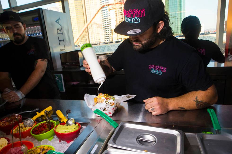 Graffiti Bao and Pina Nachos owner and chef Marc Marrone prepares nachos before the start of a ...