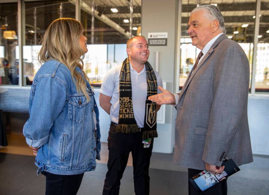 Gov. Steve Sisolak, right, chats with Todd Pollock and his daughter Carley as the Vegas Golden ...
