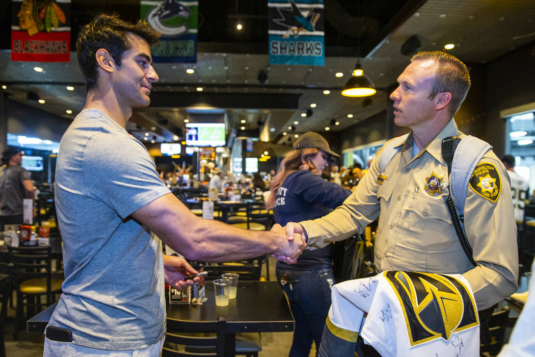 The Vegas Golden Knights Max Pacioretty, left, shakes hands with Las Vegas police detective Mik ...