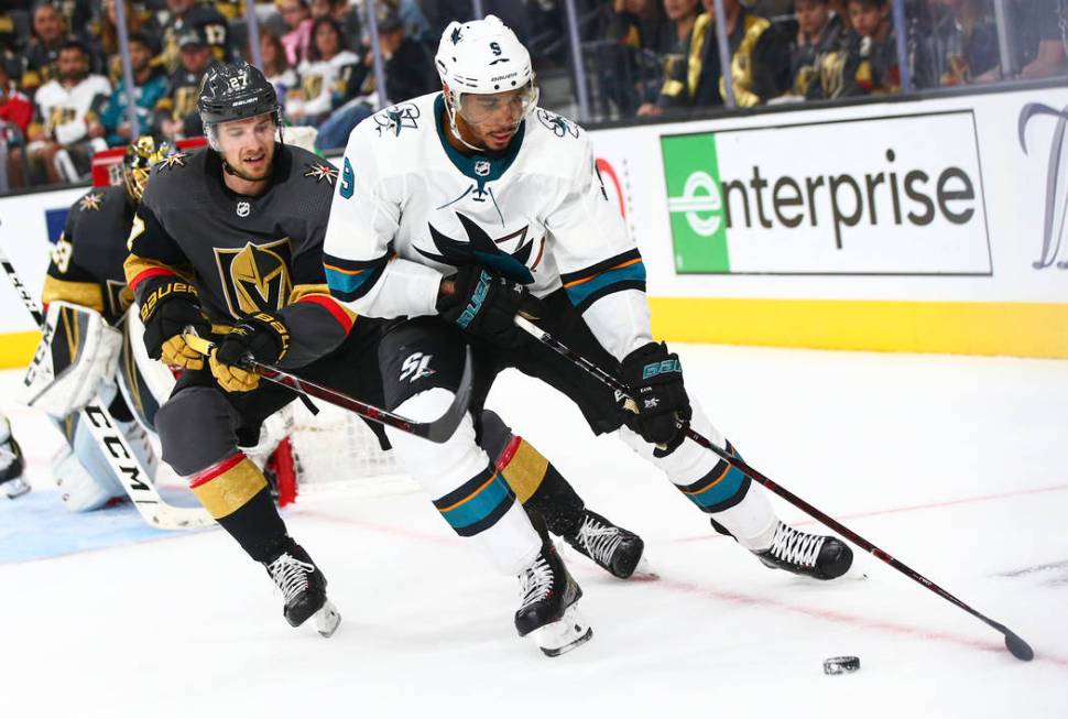 San Jose Sharks left wing Evander Kane (9) skates with the puck under pressure from Golden Knig ...