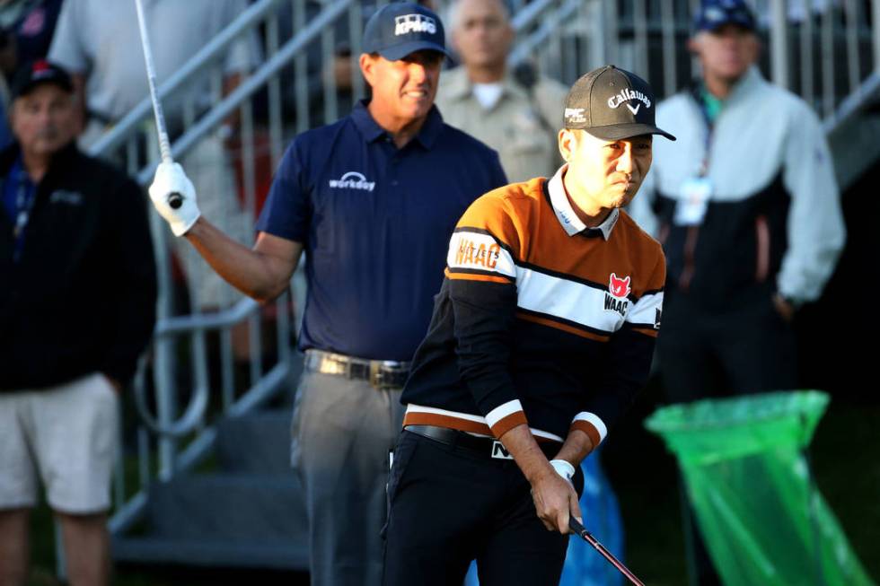 Kevin Na, right, and Phil Mickelson watch Na's tee shot on the 10th hole during Shriners Hospit ...