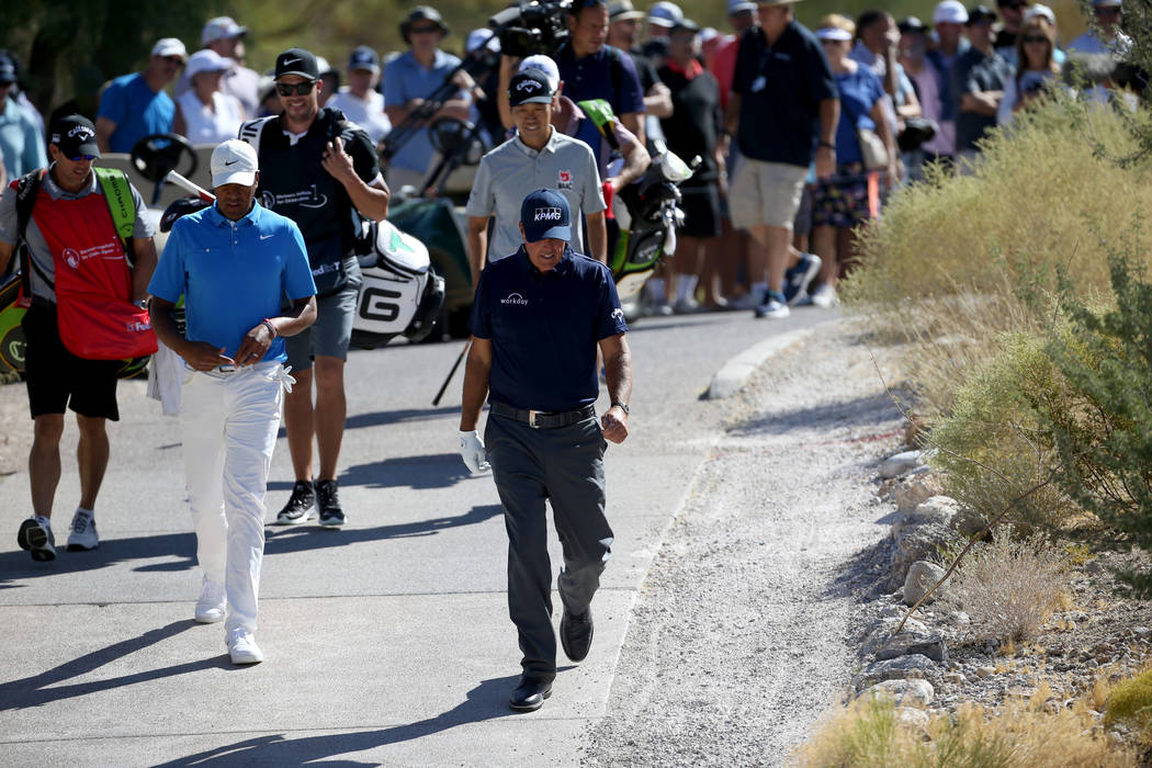 Phil Mickelson, right, Tony Finau and Kevin Na, behind Mickelson, walk the sixth hole during Sh ...