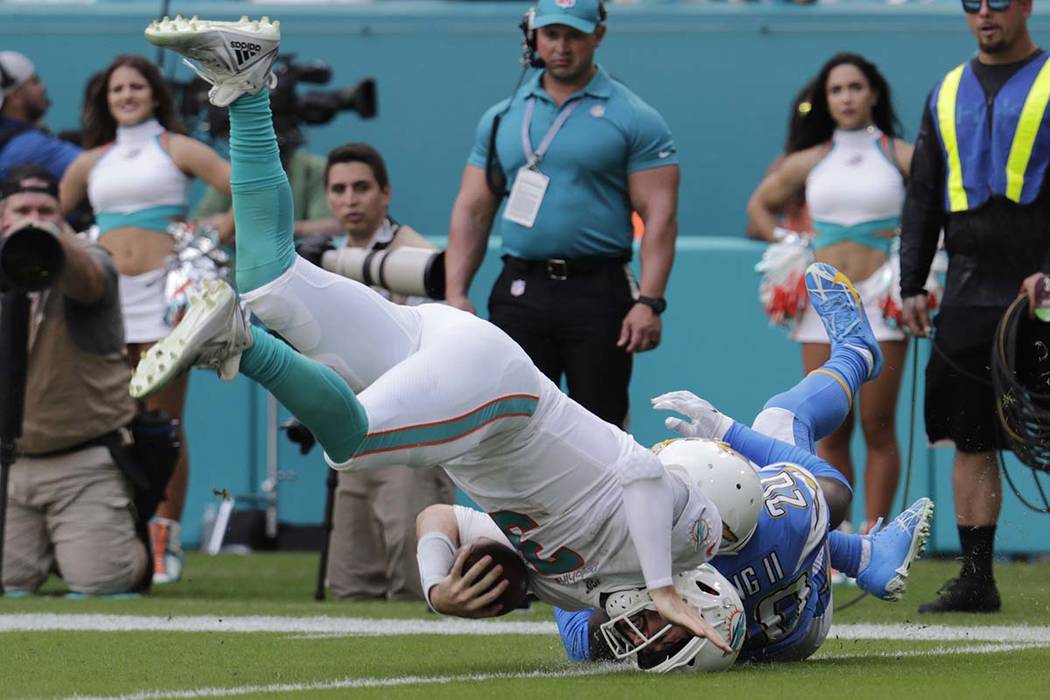 Los Angeles Chargers defensive back Desmond King (20) tackles Miami Dolphins quarterback Josh R ...