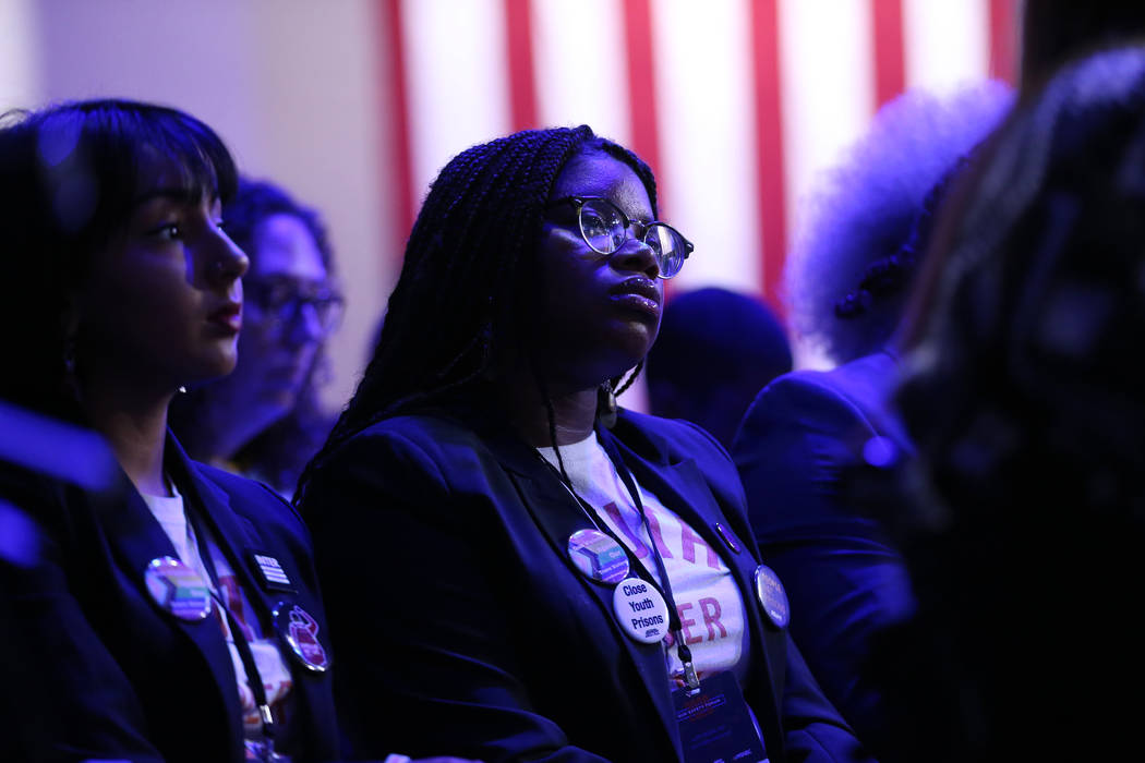 People listen to Democratic presidential candidate Pete Buttigieg speak during the 2020 preside ...