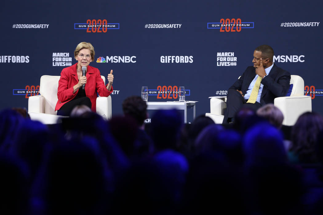 Democratic presidential candidate Elizabeth Warren, left, with forum host and journalist Craig ...