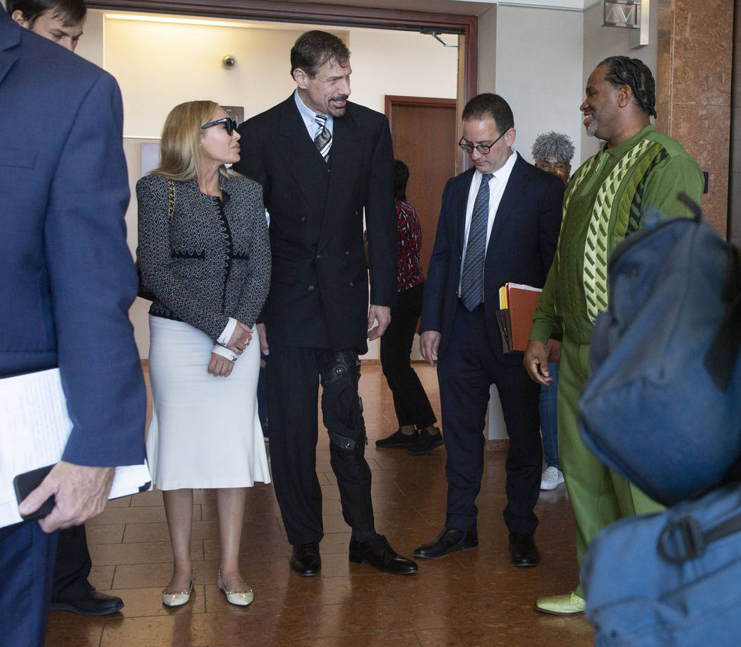 Ashley Fargo, Henry Nicholas III and defense attorney Richard Schonfeld talk with Ray Jefferson ...