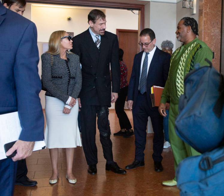 Ashley Fargo, Henry Nicholas III and defense attorney Richard Schonfeld talk with Ray Jefferson ...