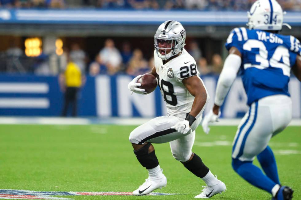 Oakland Raiders running back Josh Jacobs (28) runs past Indianapolis Colts cornerback Rock Ya-S ...