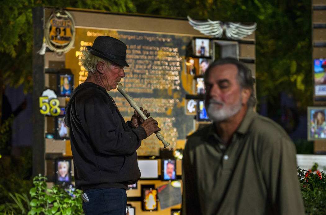 Tod Mainzer, left, plays the recorder as visitors take time out at the Las Vegas Healing Garden ...