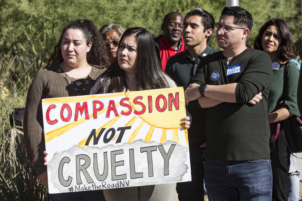 Blanca Macias, director of operations for Make The Road Nevada, holds a sign next to political ...