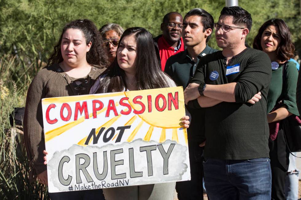 Blanca Macias, director of operations for Make The Road Nevada, holds a sign next to political ...