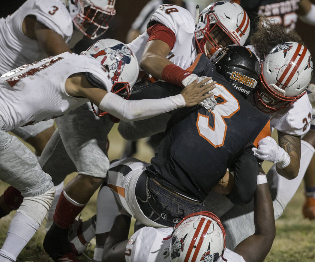 Chaparral senior running back Meshach Hawkins (3) is stacked up by a gang of Liberty defenders ...